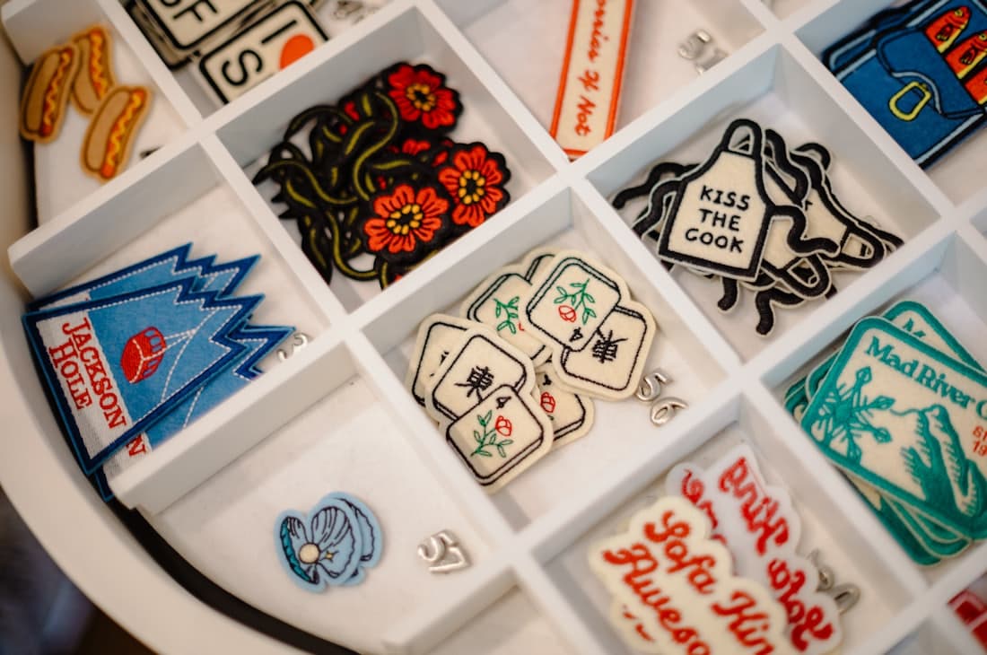 A tray of woven and embroidered patches